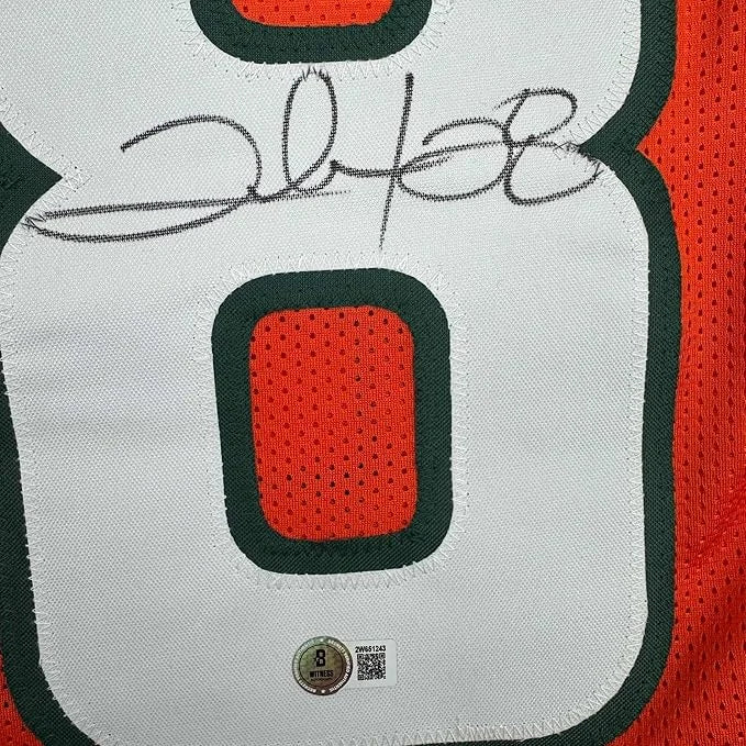 Framed autographed Clinton Portis white orange Miami Heat jersey number 8 back