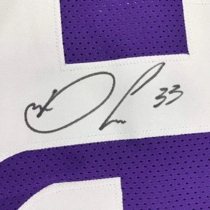 Framed autographed white and purple dalvin cook football jersey with signature and number 33 for display
