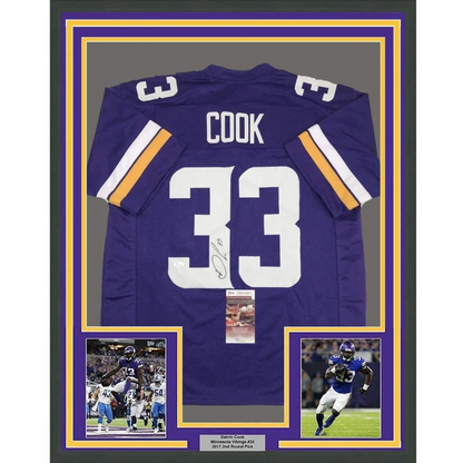 Back side of a framed autographed dalvin cook minnesota vikings purple football jersey with white and gold trim number 33