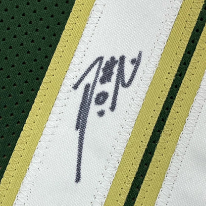 Autographed green, white, and gold Damian Lillard Milwaukee Bucks jersey with photos