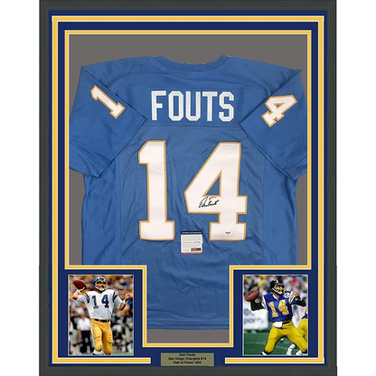 Back of a framed autographed san diego chargers powder blue football jersey with white and gold lettering