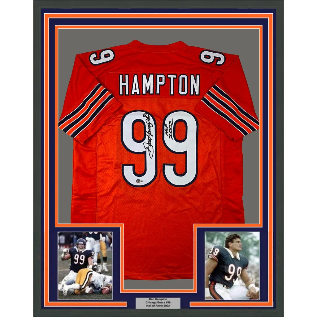 Back of a framed autographed red Chicago Bears jersey with name Hampton number 99 black and orange sleeve stripes
