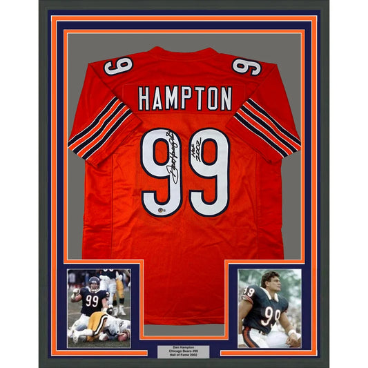 Back of a framed autographed red Chicago Bears jersey with name Hampton number 99 black and orange sleeve stripes