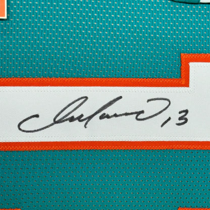 Autographed teal Dan Marino Jersey with orange and white trim ready for display