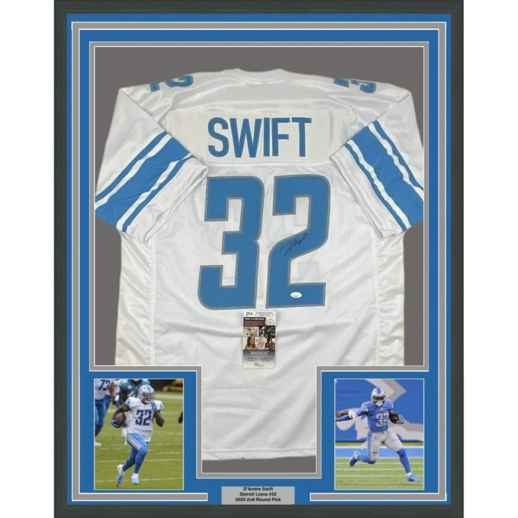 Back of white and blue Detroit Lions football jersey with name swift and number 32 signed by DAndre Swift framed 35x39