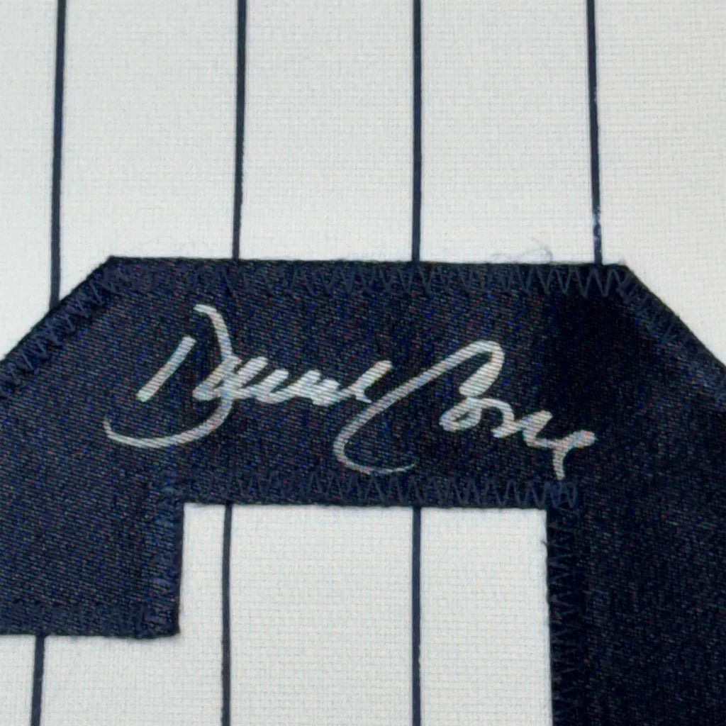 Autographed pinstriped Yankees jersey with dark number in museum frame display