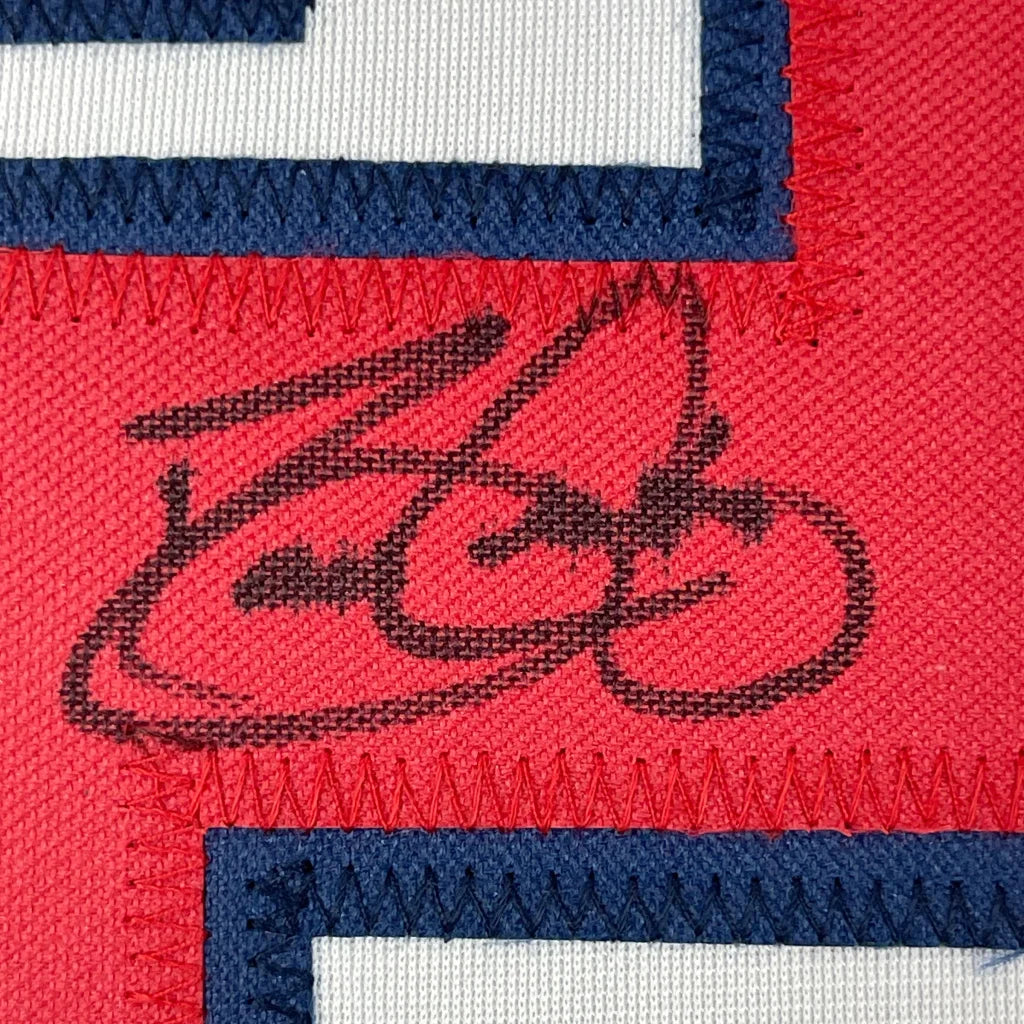 Red embroidered David Justice cursive signature patch on framed Atlanta jersey