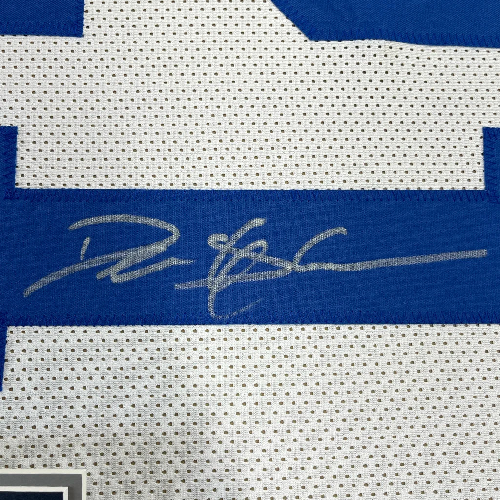 Framed autographed deion sanders dallas white football jersey with blue perforated mesh and silver signature across chest