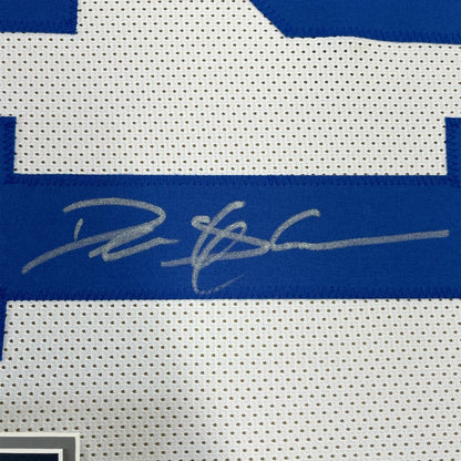 Framed autographed deion sanders dallas white football jersey with blue perforated mesh and silver signature across chest