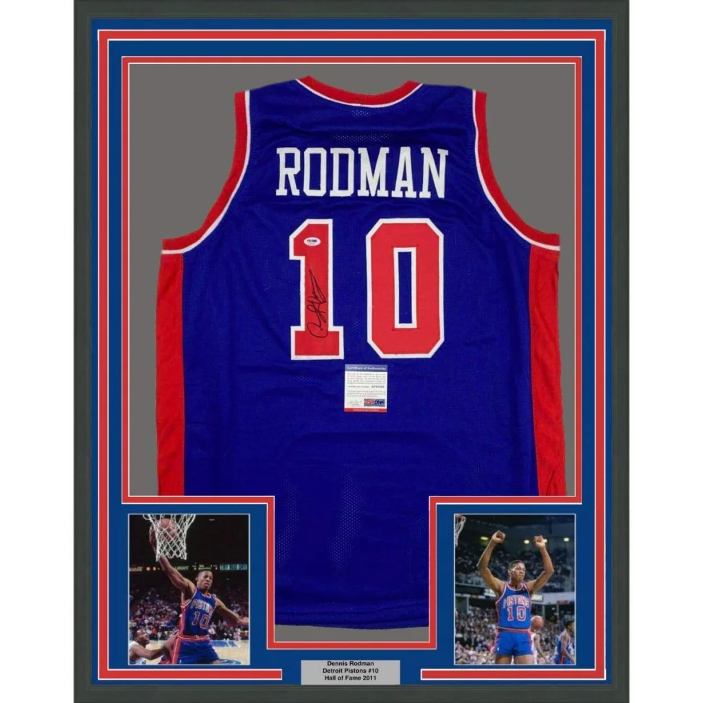 A framed royal blue Detroit Pistons #10 Dennis Rodman autographed basketball jersey with red and white trim and signature below number