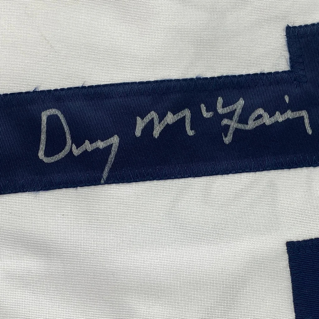 Framed autographed Denny McLain Detroit Tigers jersey with navy satin ribbon and silver signature, JSA COA