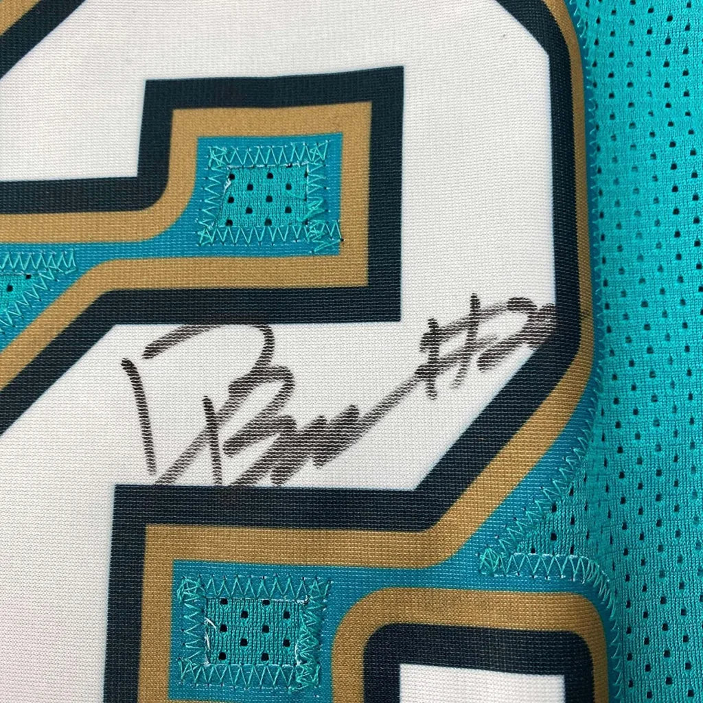 White Memphis Grizzlies jersey with teal and gold trim and a black autograph