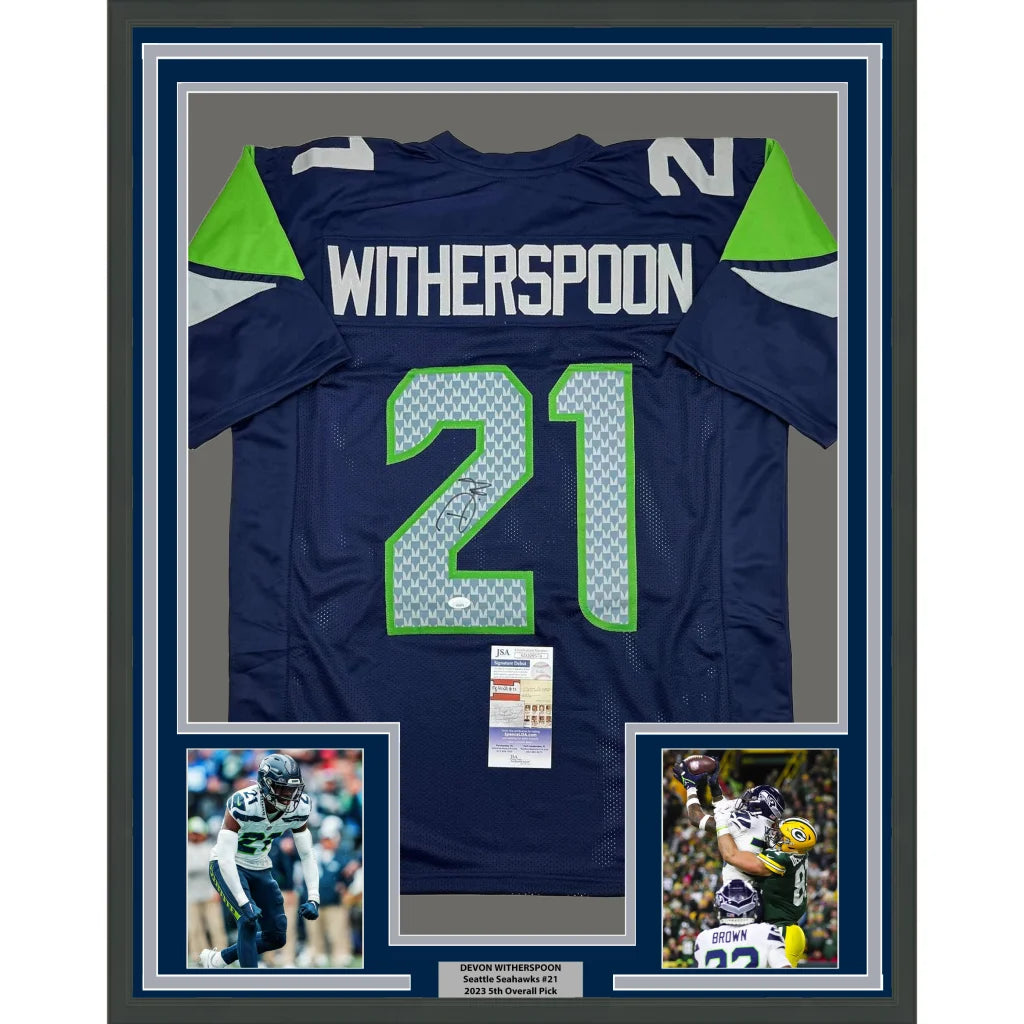 Framed Devon Witherspoon Seahawks jersey with autographs, action photos, and JSA COA for your man cave