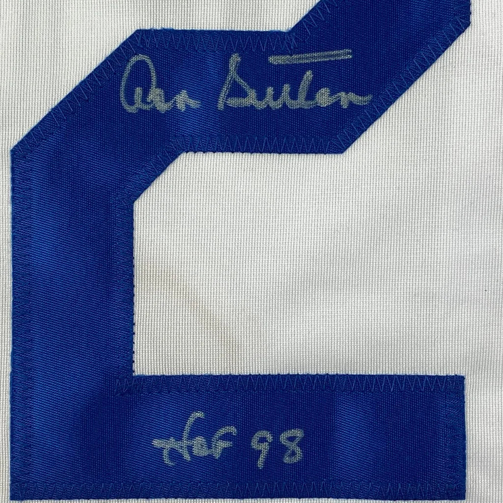 White fabric with blue number 2 patch and signatures on Signed Baseball Jersey