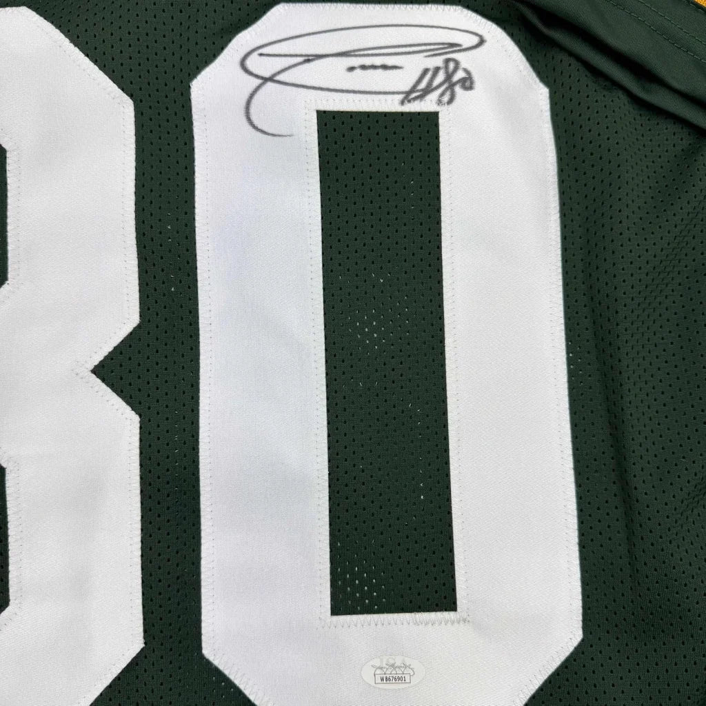 Green sports jersey with white numbers and signature from custom professional sports league jersey