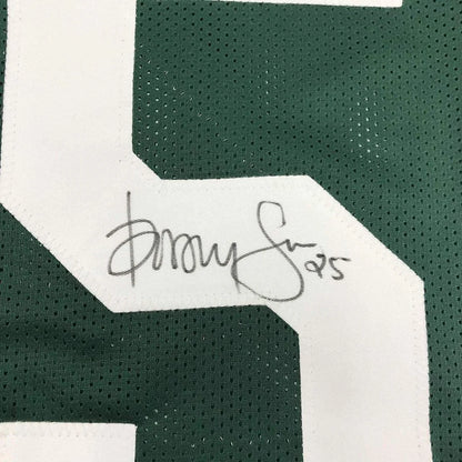 Framed autographed green and white mesh green bay packers football jersey with signature on white trim