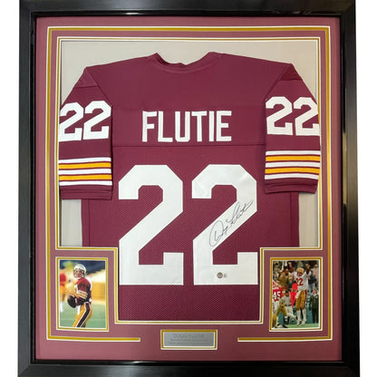 Framed signed Doug Flutie #22 maroon football jersey with two photos for fans