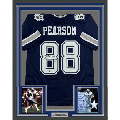 Framed autographed navy dallas cowboys football jersey with white silver accents, signed by drew pearson, back view with name pearson and number 88