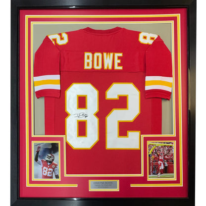 Back side of a framed autographed kansas city chiefs red football jersey with white and yellow bowe 82 numbering