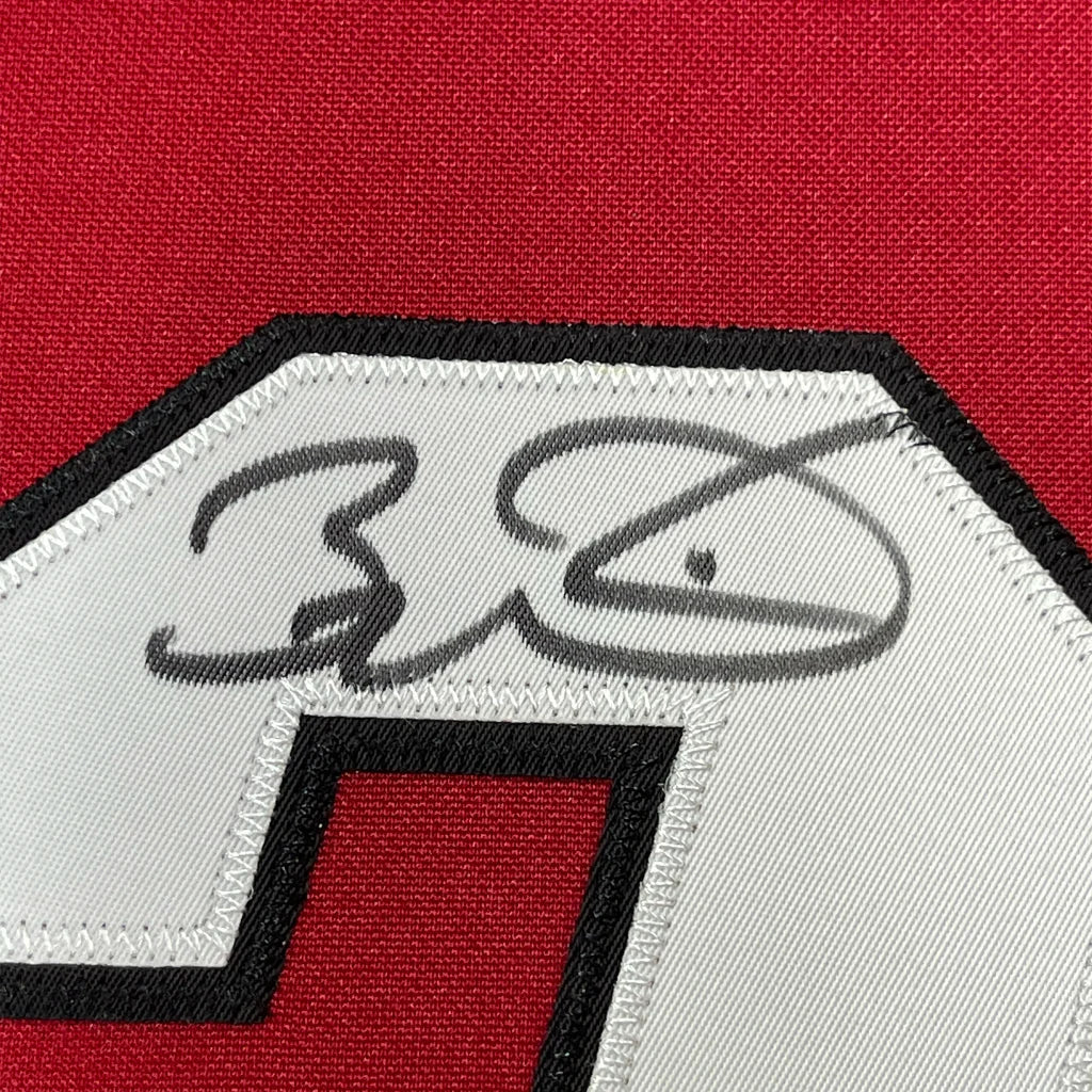 Red Miami Heat jersey with Dwyane Wade autograph and black white patch for display