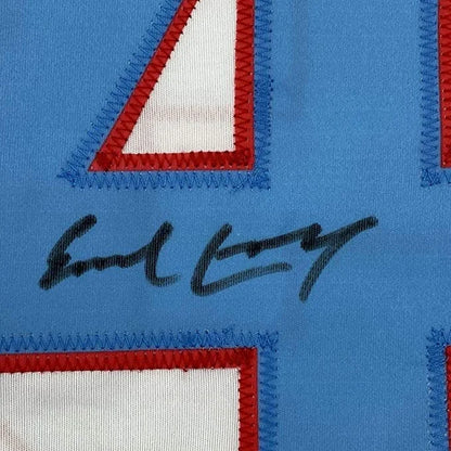 Framed autographed Earl Campbell Houston white football jersey with blue jersey, red white numerals, black signature, Beckett BAS COA
