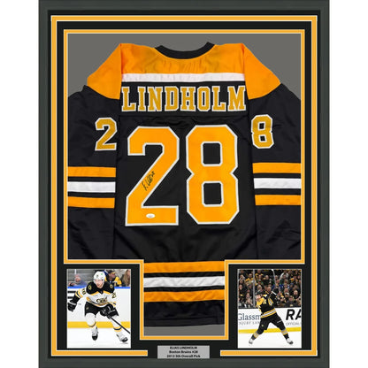 Framed Boston Bruins jersey with autograph and player photos ready to hang