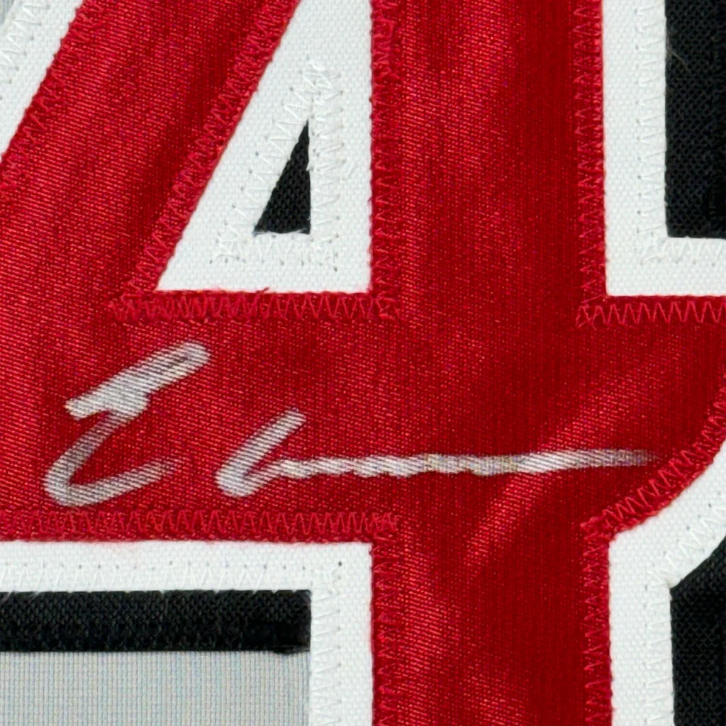 Red baseball jersey with white trim and silver autograph perfect for display
