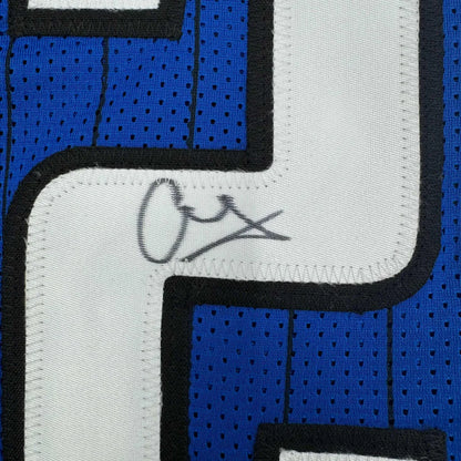 Blue sports jersey with white number and signature, professionally framed for display