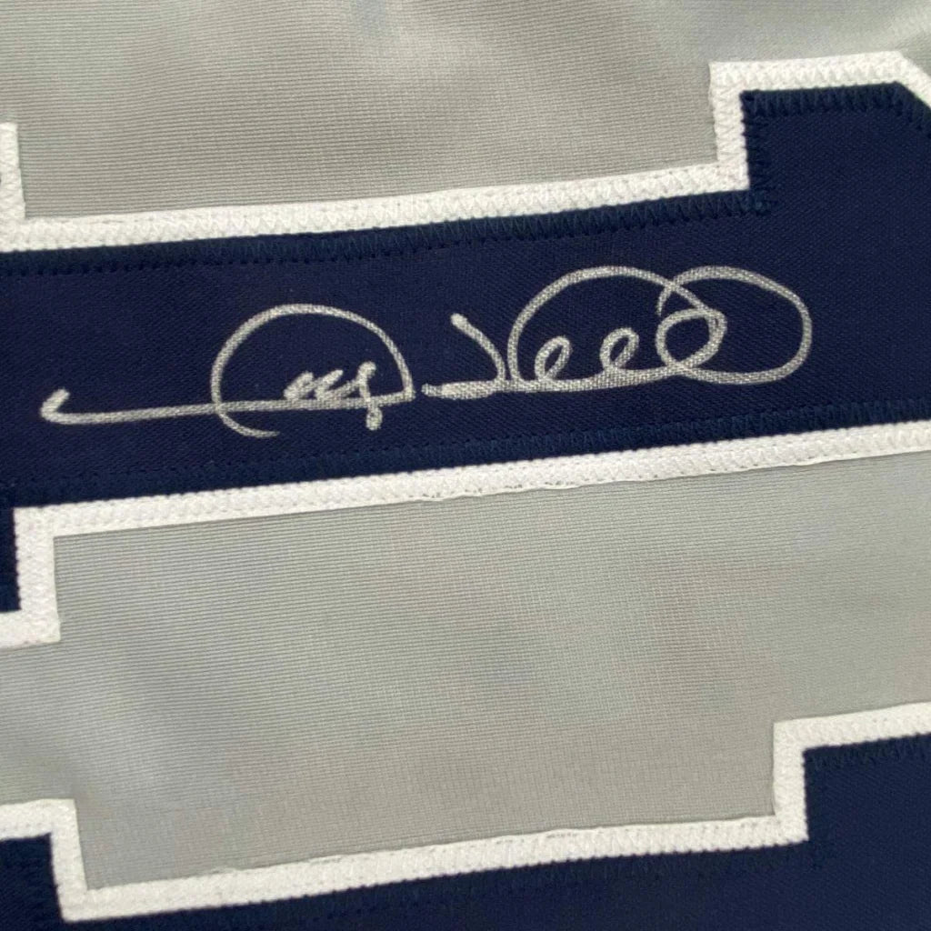 Autographed Dallas Cowboys jersey in a professionally framed man cave display with PSA DNA COA