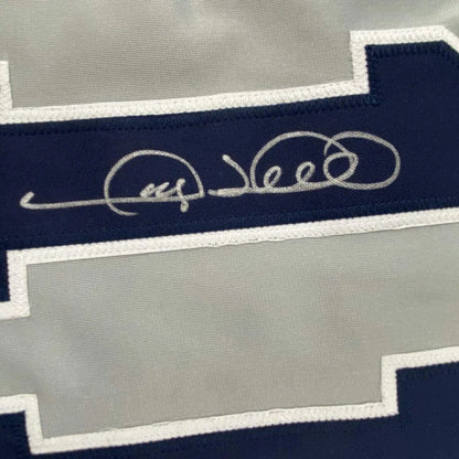 Autographed Dallas Cowboys jersey in a professionally framed man cave display with PSA DNA COA