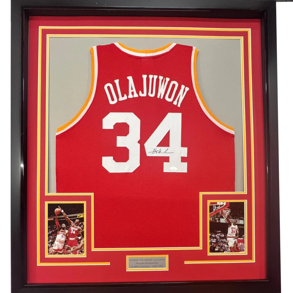 Framed Autographed Hakeem Olajuwon 35x39 Houston Red Basketball Jersey Beckett BAS COA | Hall of Fame Sports Memorabilia | vintageantiquesgifts.com