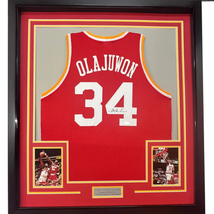 Framed Autographed Hakeem Olajuwon 35x39 Houston Red Basketball Jersey Beckett BAS COA | Hall of Fame Sports Memorabilia | vintageantiquesgifts.com