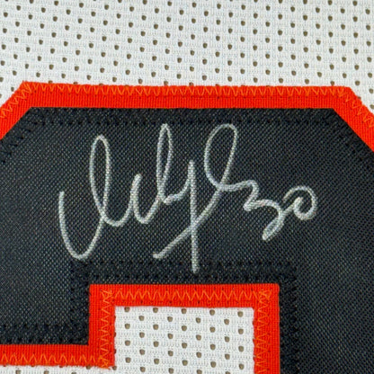 Autographed black and orange sports jersey for the ultimate man cave display