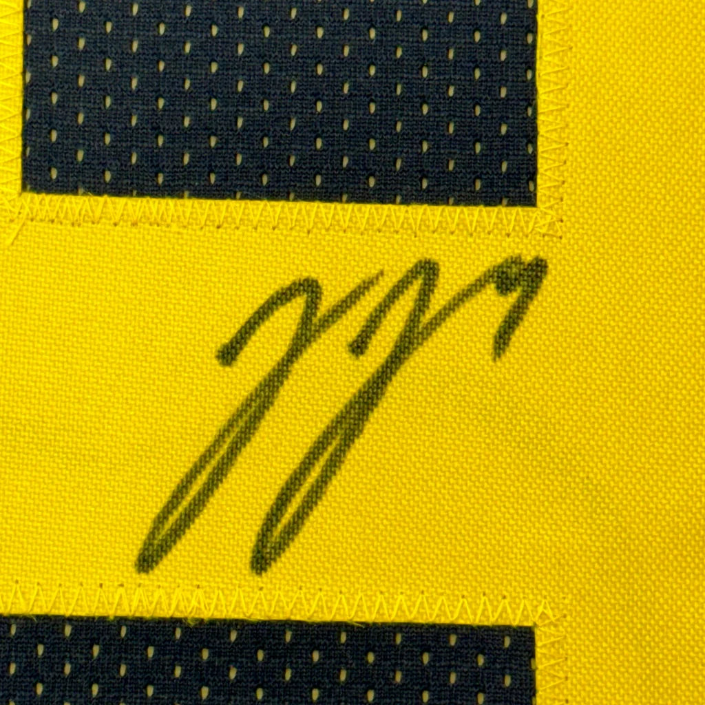 Signed yellow and black Michigan Wolverines jersey framed with photos