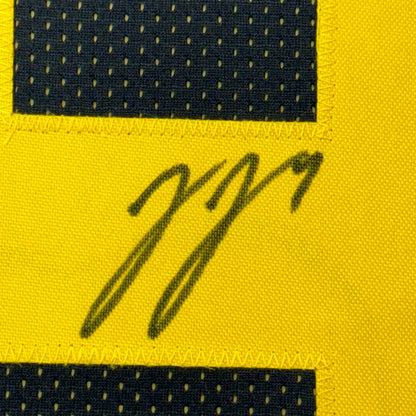 Signed yellow and black Michigan Wolverines jersey framed with photos