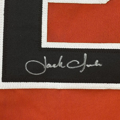 Framed autographed Jack Clark San Francisco orange baseball jersey with black and orange woven scarf, white trim, and silver thread signature, 35x39 inches, JSA COA