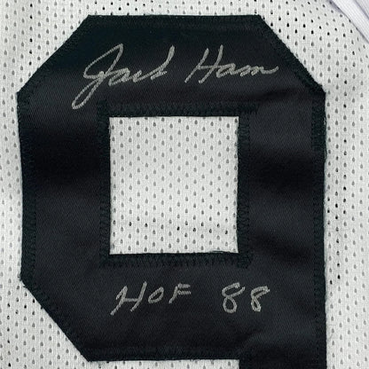 Autographed black and white Jack Ham sports jersey with action photos frame