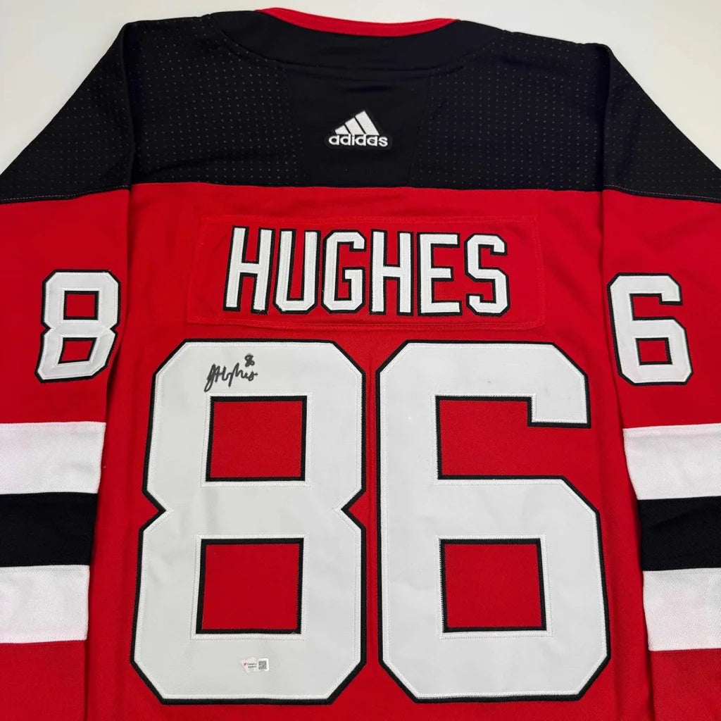 Red and black Jack Hughes New Jersey Devils jersey with white numbers, autographed and framed