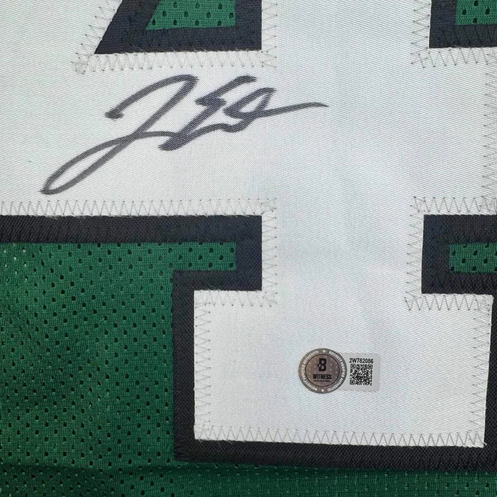 White and green custom jersey from a professional sports league with autograph and auth sticker