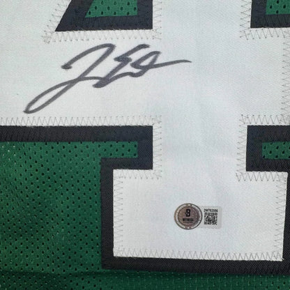 White and green custom jersey from a professional sports league with autograph and auth sticker