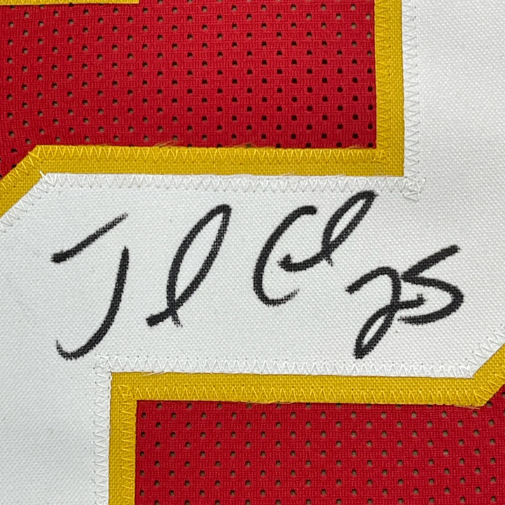 Black ink signature on white fabric patch with yellow stitching on red mesh jersey of framed signed jamaal charles football jersey
