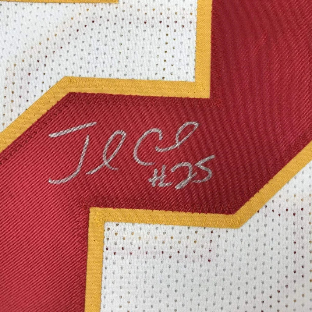Framed autographed red and white mesh football jersey with yellow trim signed by jamaal charles in silver thread