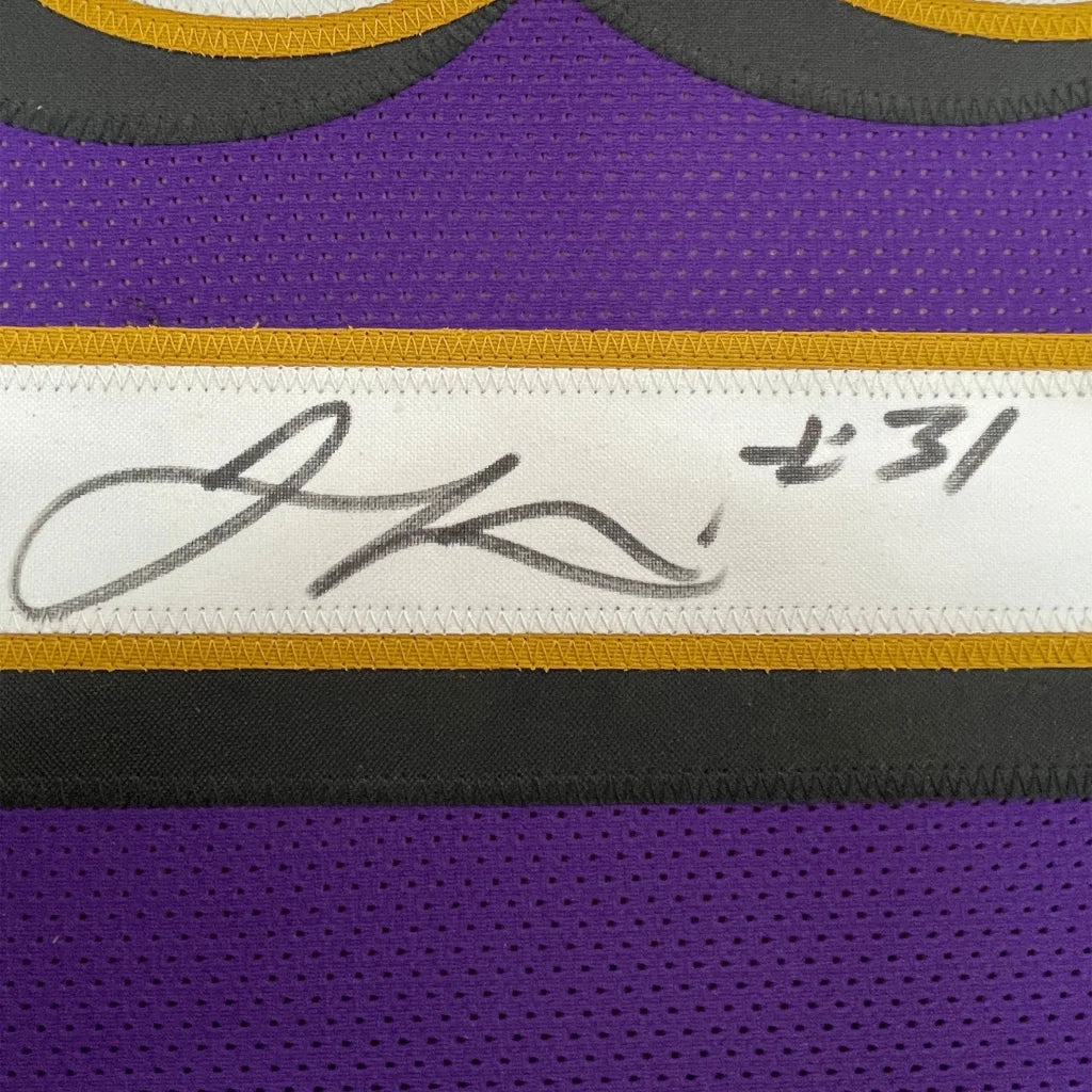 Autographed purple Jamal Lewis Ravens jersey in professionally framed display