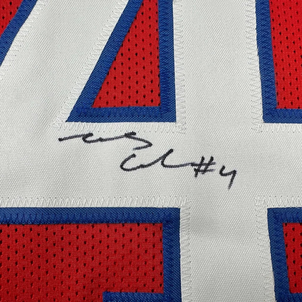 White number 4 sports jersey with red blue accents in man cave display