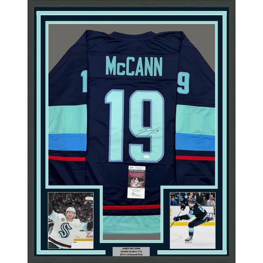 Framed autographed navy blue seattle kraken hockey jersey with teal stripes featuring mccann 19 on the back