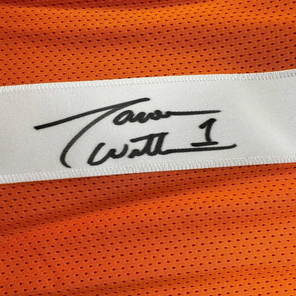 A white label with a black tavon wilson signature stitched on bright orange mesh in a framed signed jason witten jersey