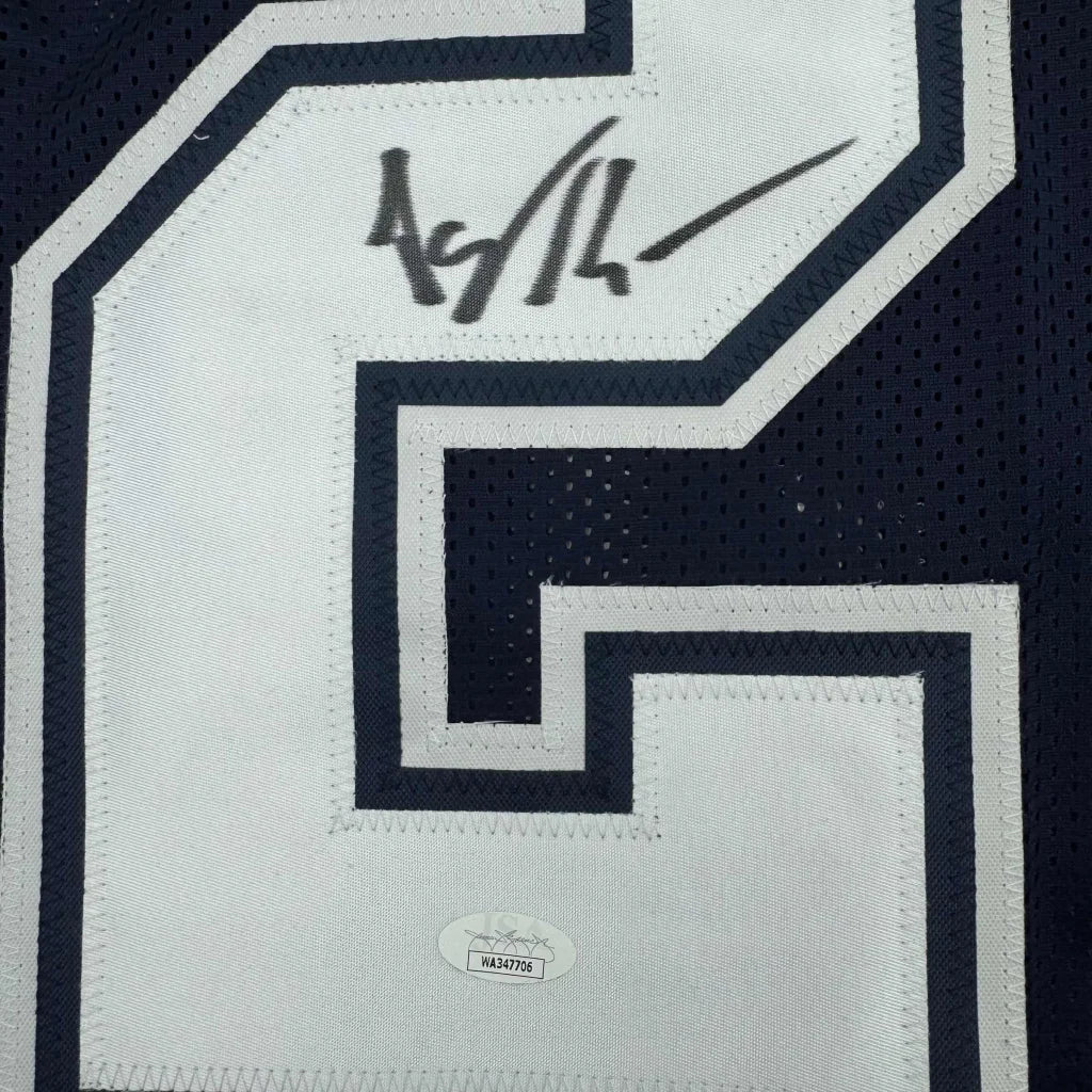 Autographed Dallas Cowboys Kearse jersey with certification sticker and photos inside