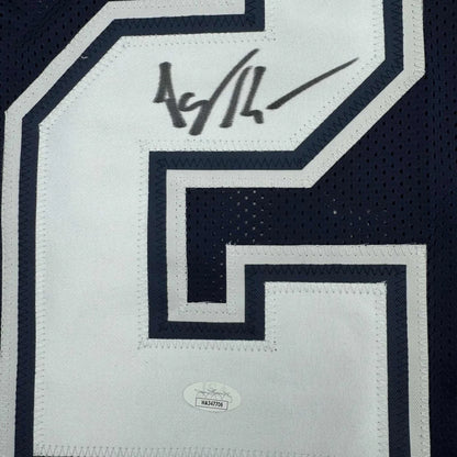 Autographed Dallas Cowboys Kearse jersey with certification sticker and photos inside