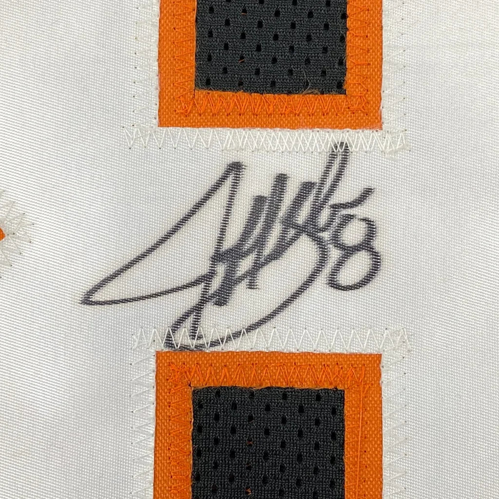 White fabric with orange and black accents and a black autograph on Bengals jersey