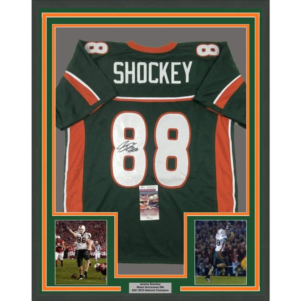 Framed autographed Miami hurricanes green and orange football jersey with name Shockey and number 88 signed by Jeremy Shockey